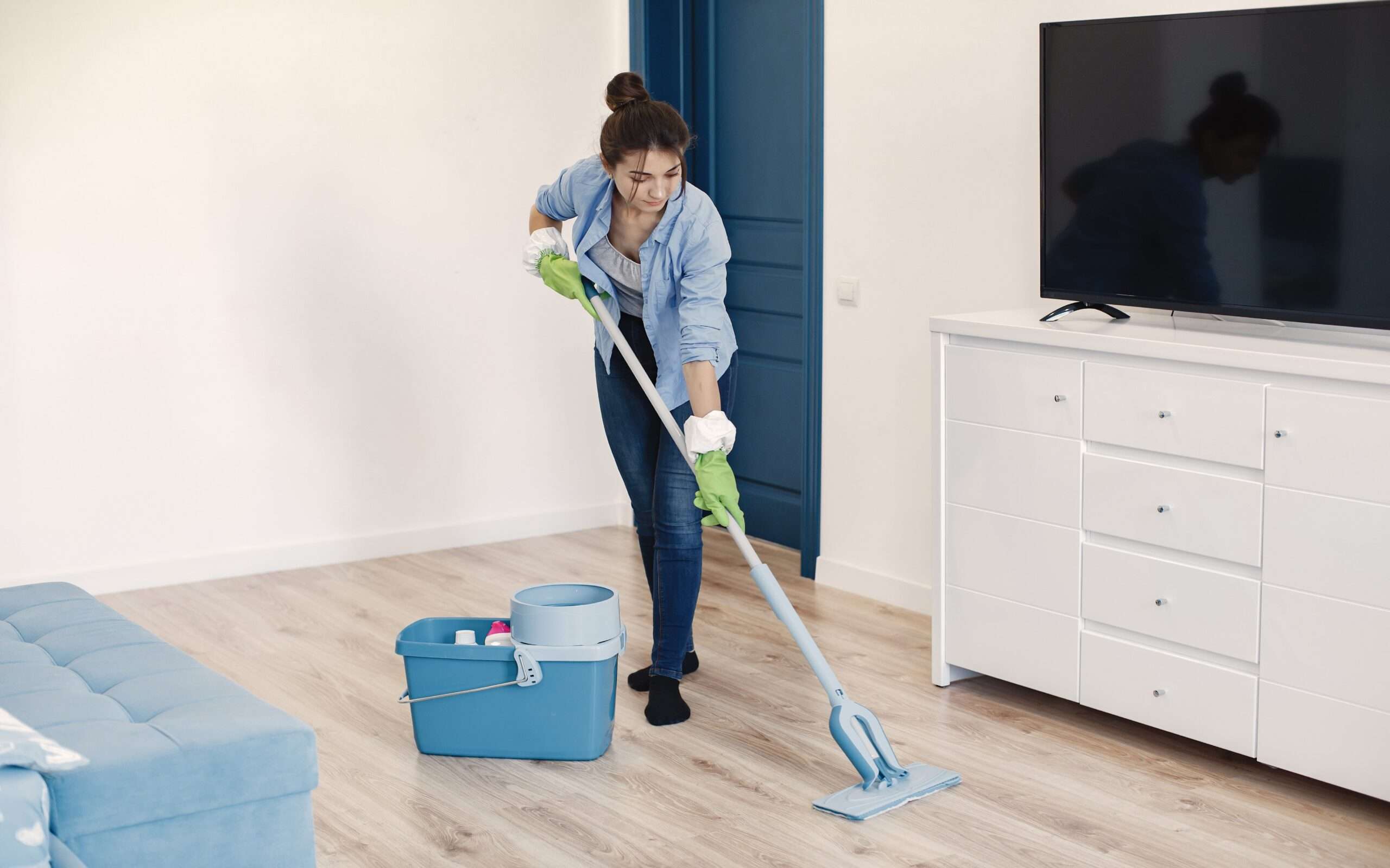 housewife woking home lady blue shirt woman clean floor min scaled